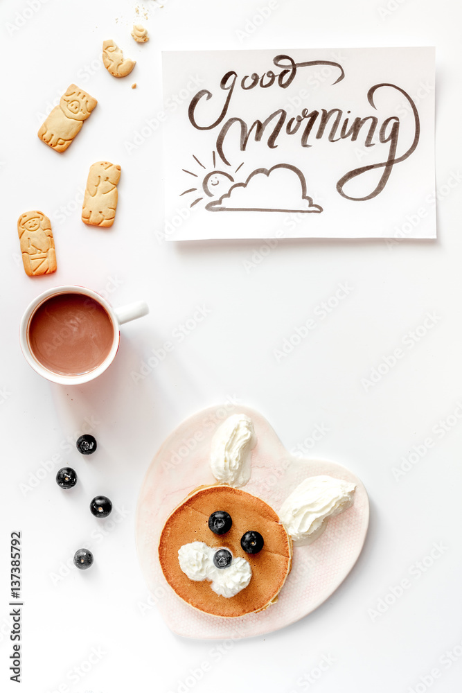 concept kid breakfast with pancake top view on white background