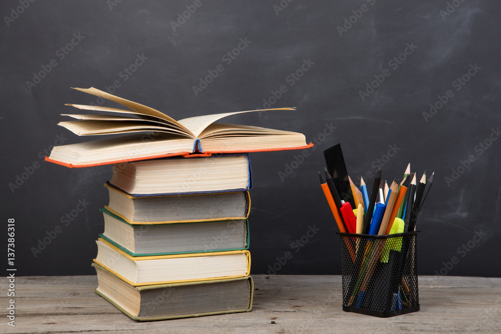 Education concept - books on the desk in the auditorium