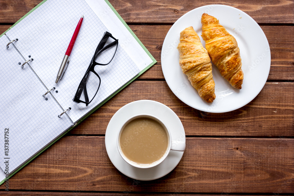 Business breakfast with coffee and croussant top view