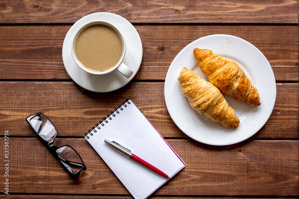 Business breakfast with coffee and croussant top view