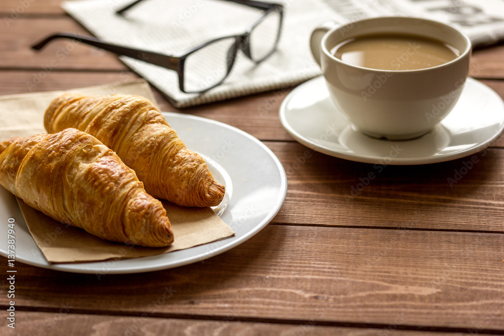 Businessman morning cup of coffee at home with newspaper