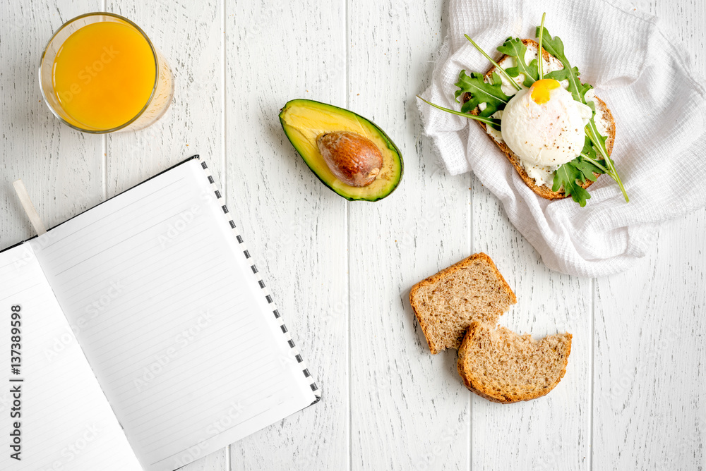 sandwich with poached eggs on wooden background top view mockup