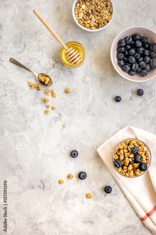 Oat flakes with honey and berries on table background top view