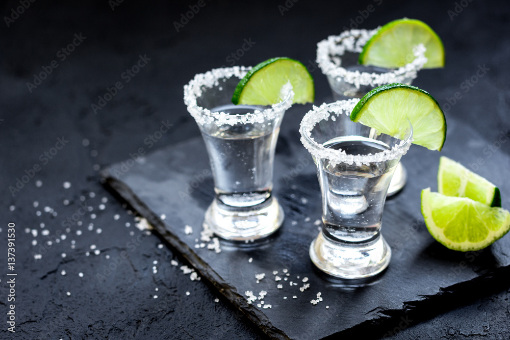 Set for tequila party with lime and salt on black background