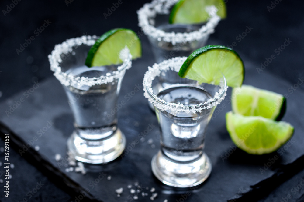 Set for tequila party with lime and salt on black background