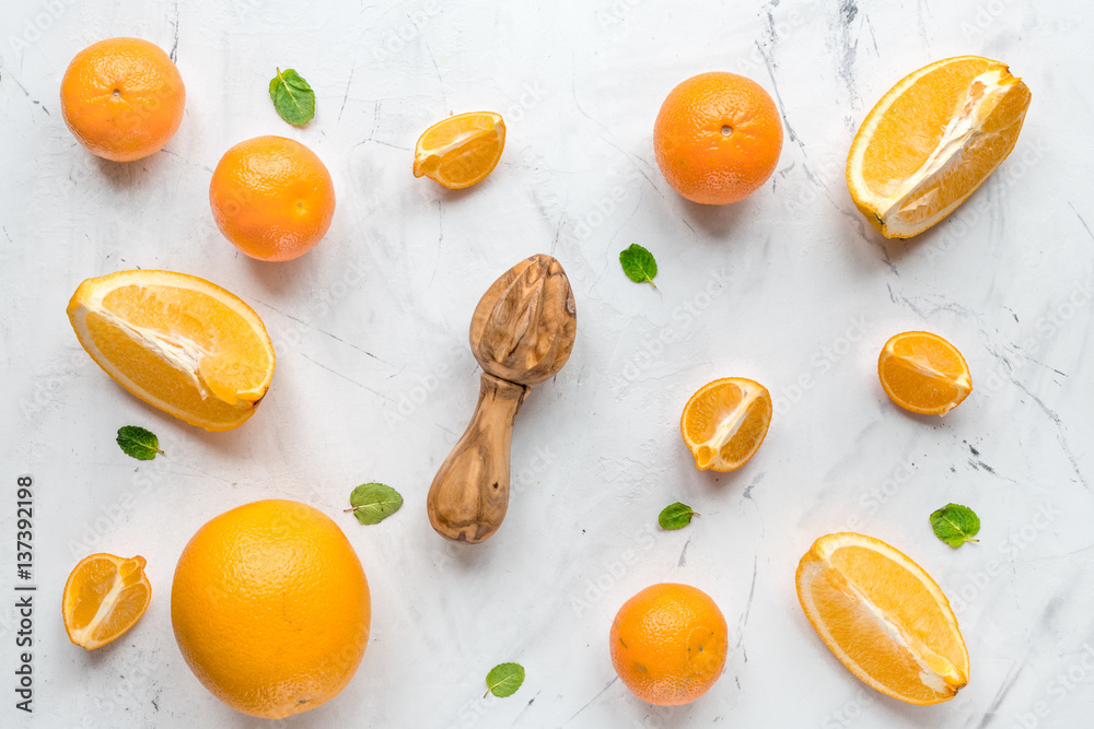 Making orange juice with mint on table background top view pattern