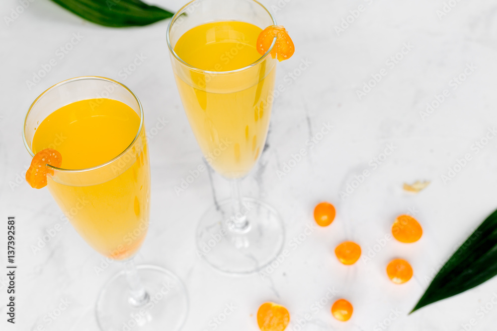 cocktail with physalis in glass on stone background