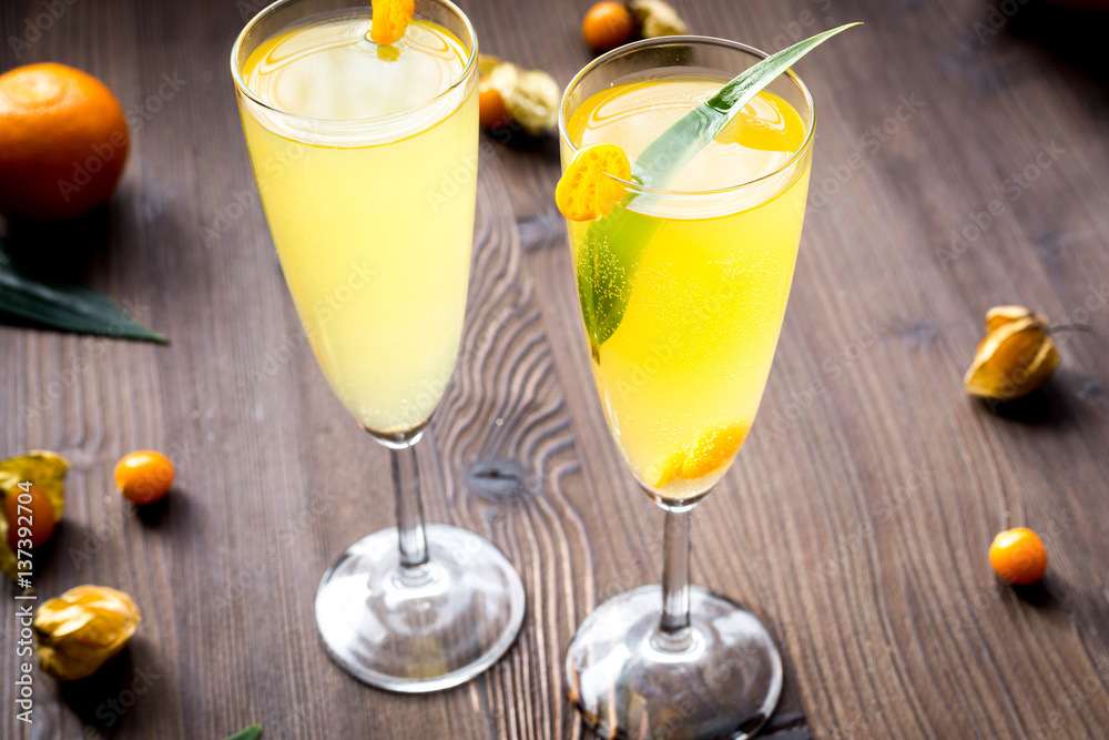 cocktail with physalis in glass on wooden background