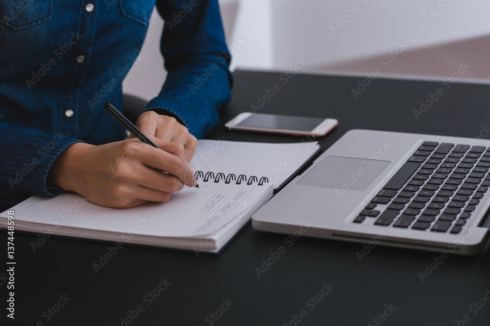 Closeup of Girl hands writing report. Taking notes.