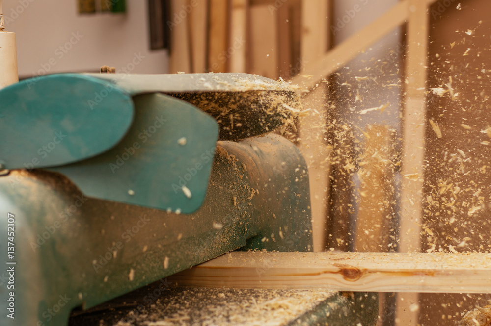 Carpenter working in a dusty workshop