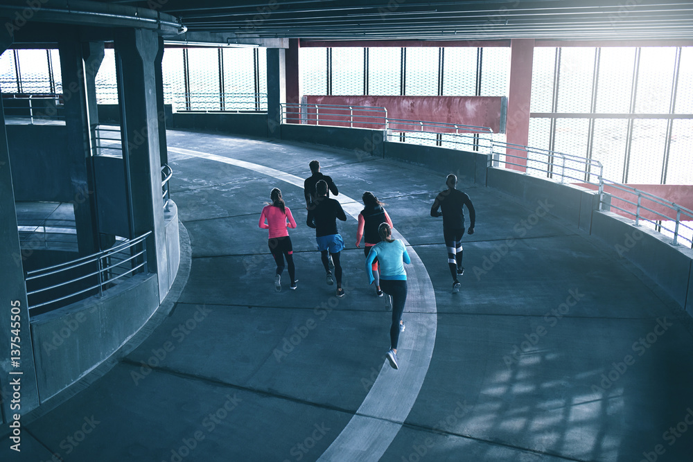 Young sportspeople running at athletic field