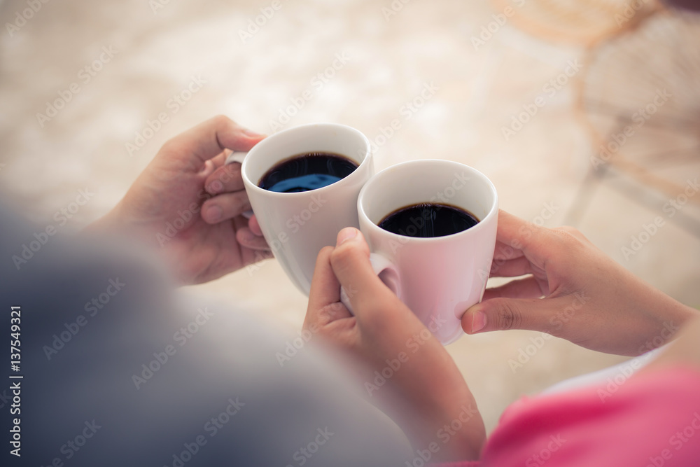 Peaceful asian young couple relaxing at home with cup of tea