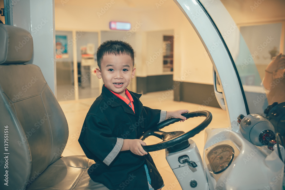 Asian boy child having fun in indoors playground