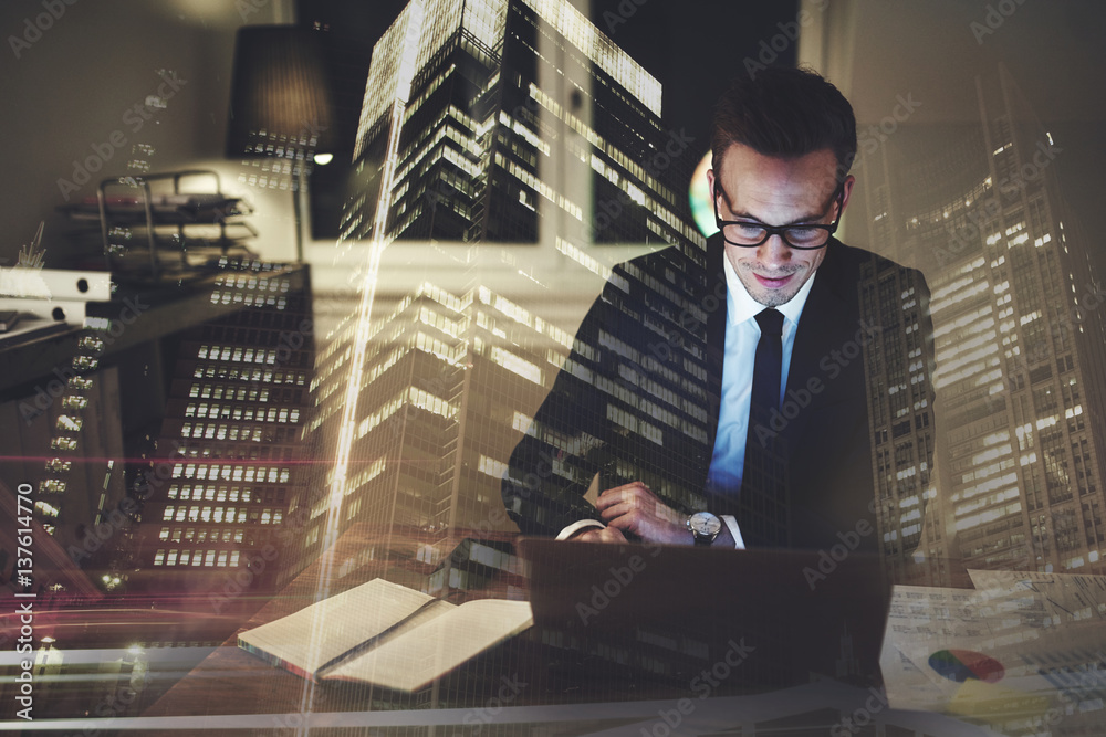 Optimistic businessman working on laptop