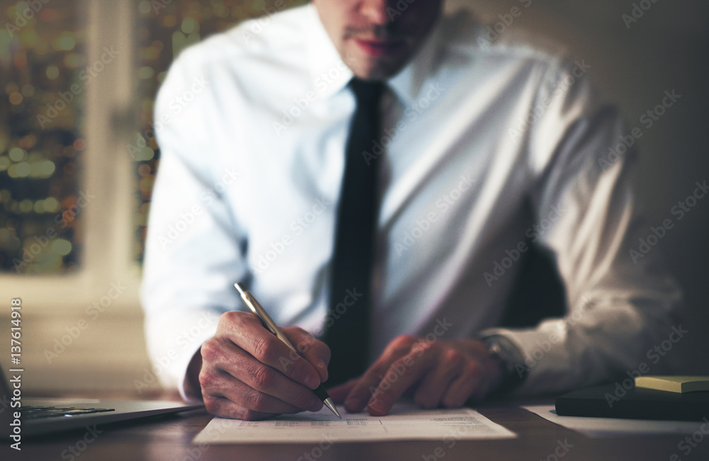 Businessman signing document