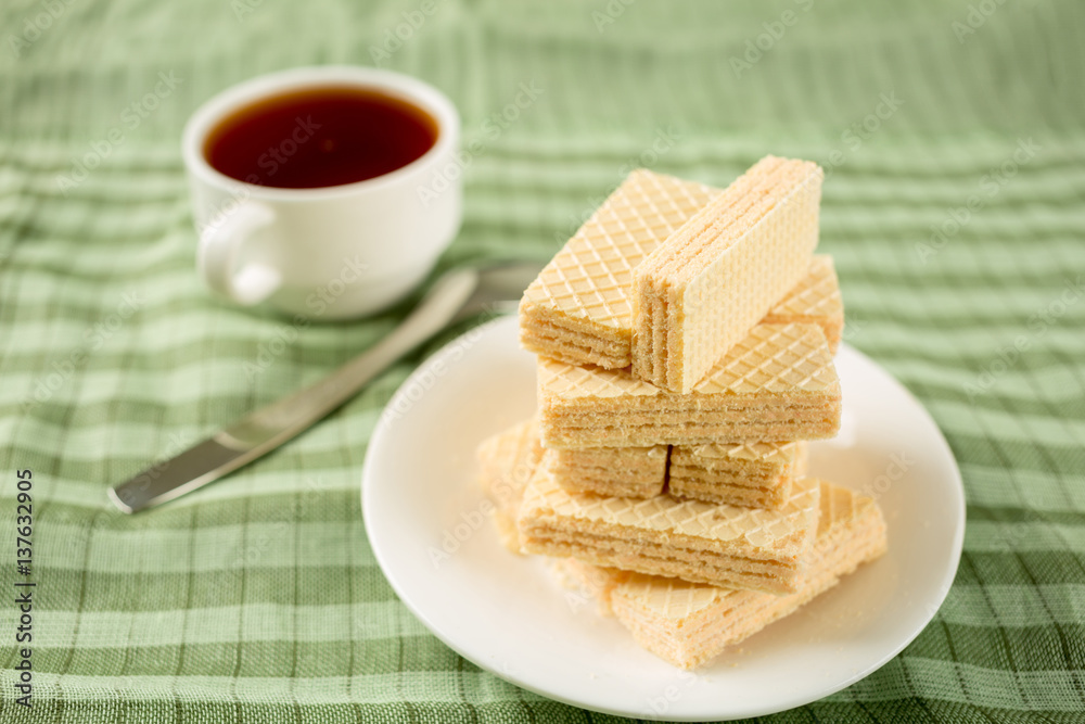 Wafer biscuits served with tea.