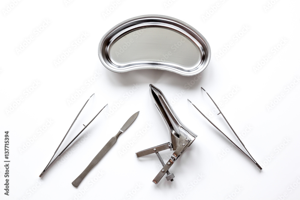 instruments of gynecologist on white background top view