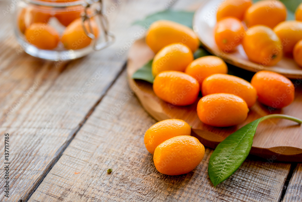 kumquat on plate at wooden table