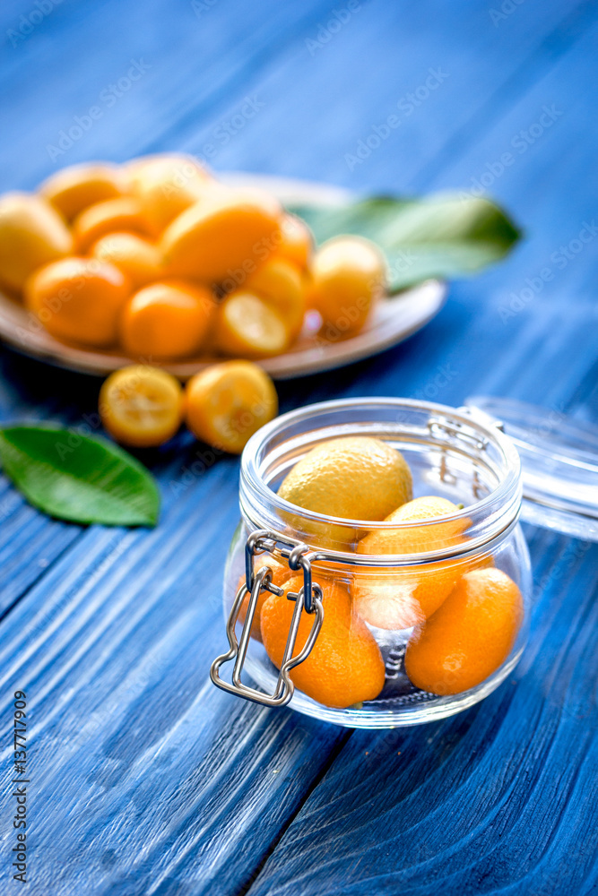 kumquat on plate at wooden table