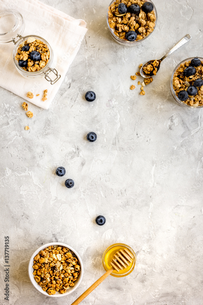 Oat flakes and berries granola glass on table background top view