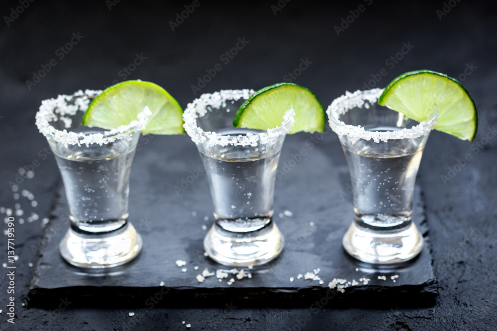 Set for tequila party with lime and salt on black background