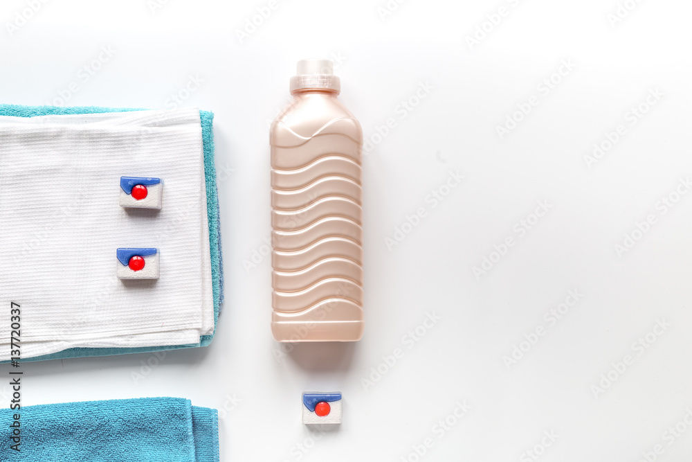 housekeeping set with towels and plastic bottles in laundry top view mockup