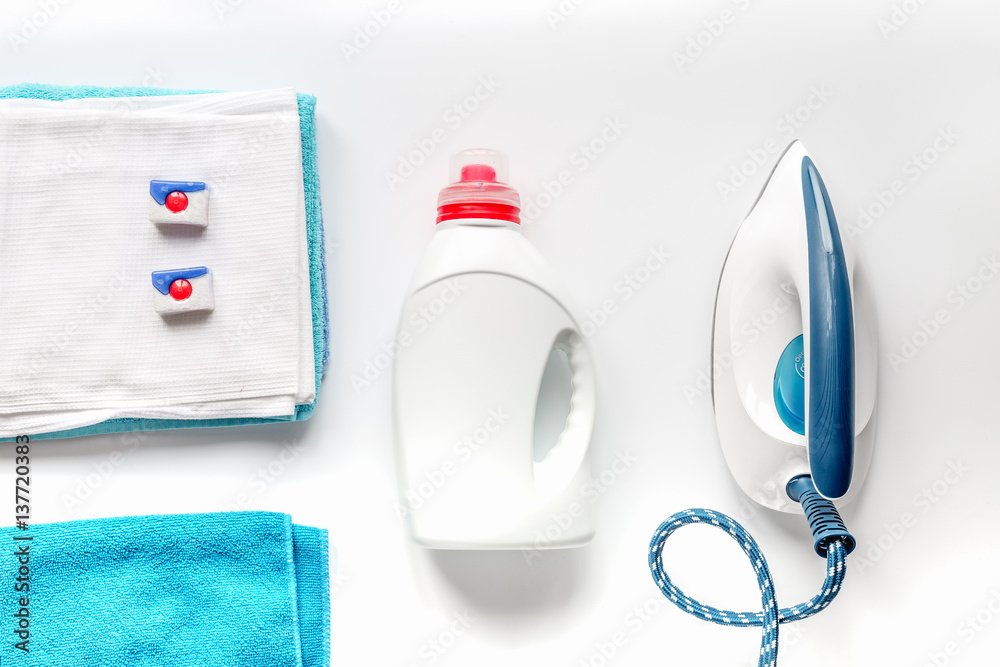 laundry set with towels and plastic bottels on white background top view