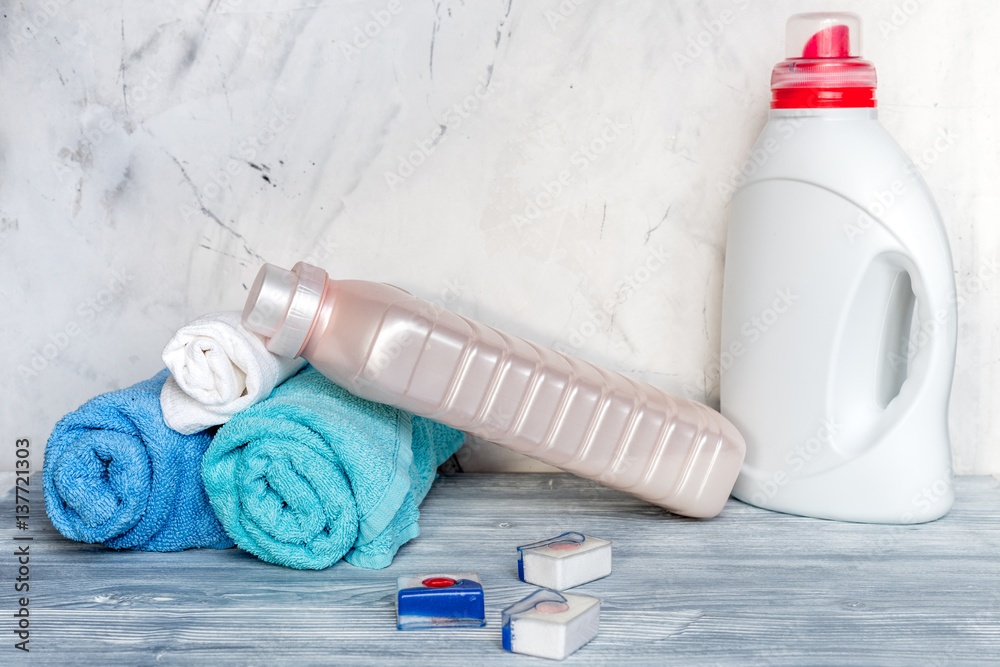 housekeeping set with towels and plastic bottles on laundry background mockup