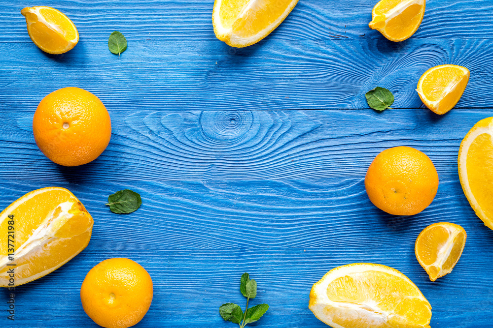 sliced oranges for lunch on blue background top view mockup