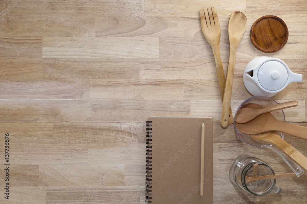 blank notebook with cooking accessory on wood,concept cooking menu background.