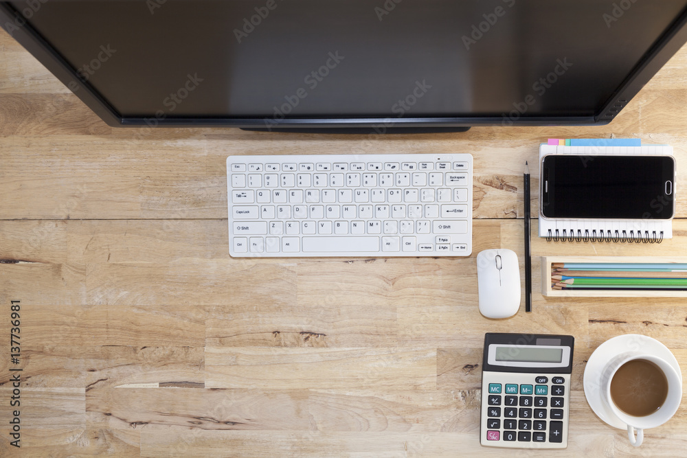 Top view with wood table, computer with keyboard,paper note,pencil,airplane model,flower,smartphone 