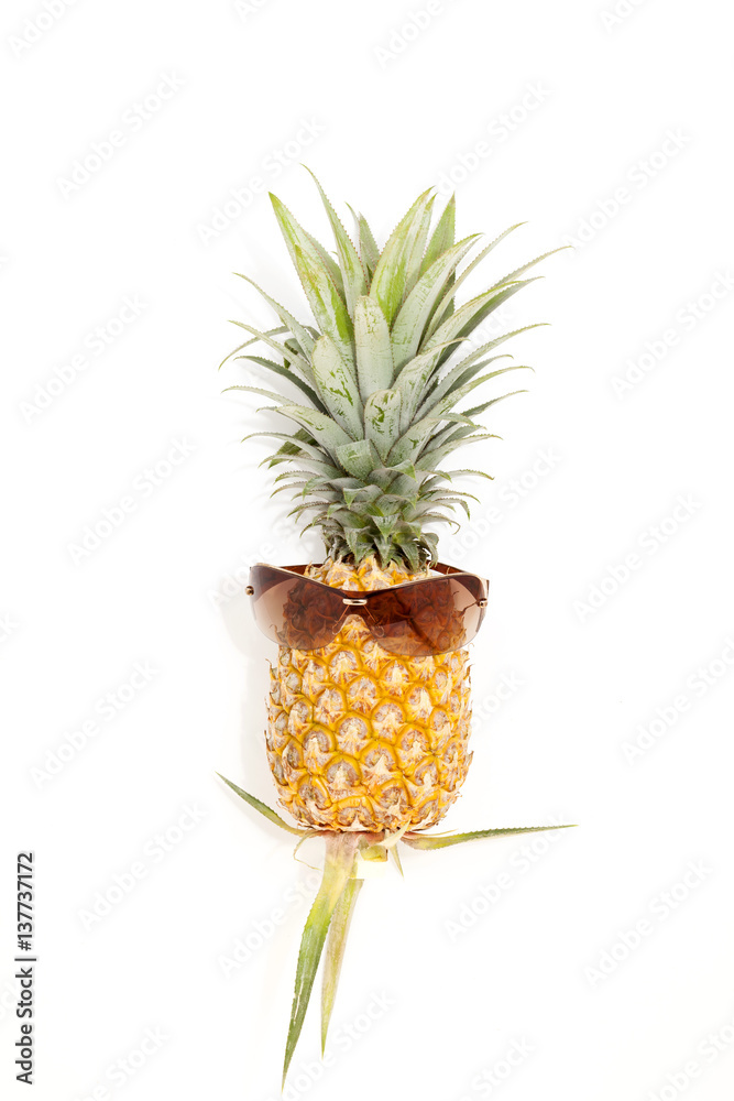 pineapple with sunglasses on white background.