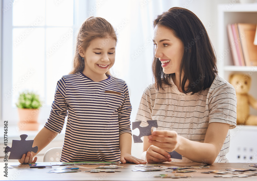 Mother and daughter do puzzles