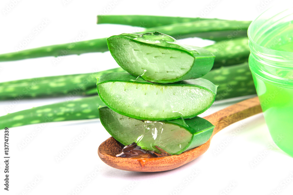 the sliced and leaf of fresh aloe vera with aloe vera gel product on  wooden plate , natural clear g