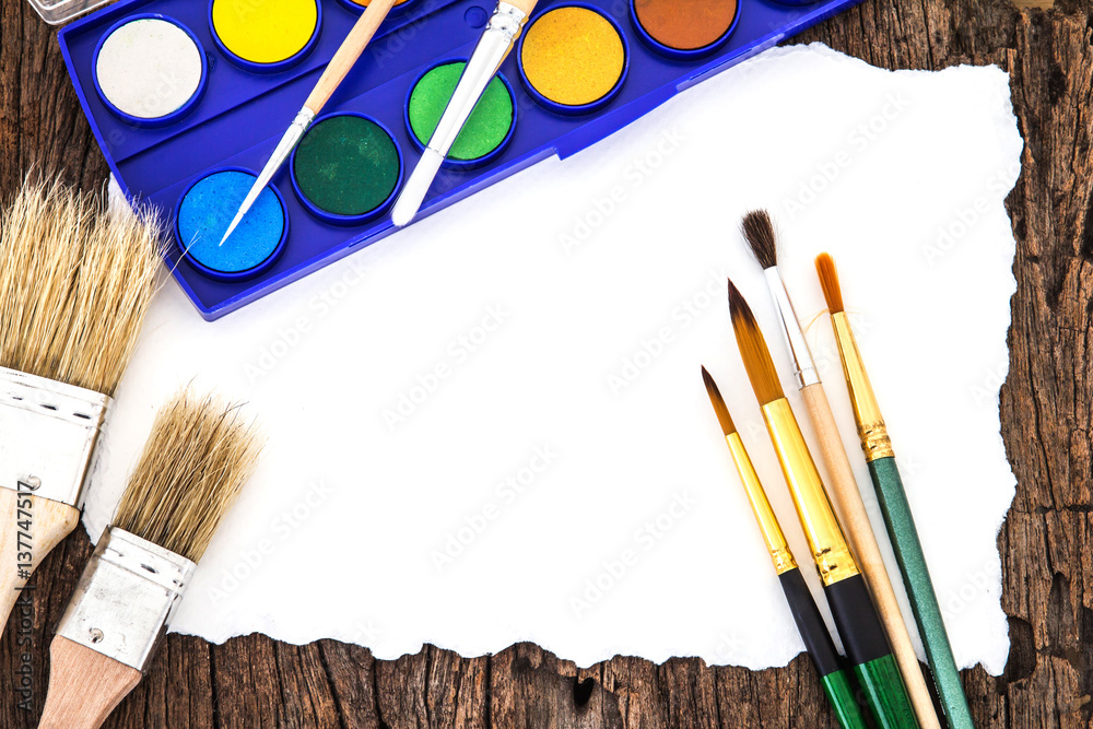 Art brush watercolor paint with white paper art  on wooden background