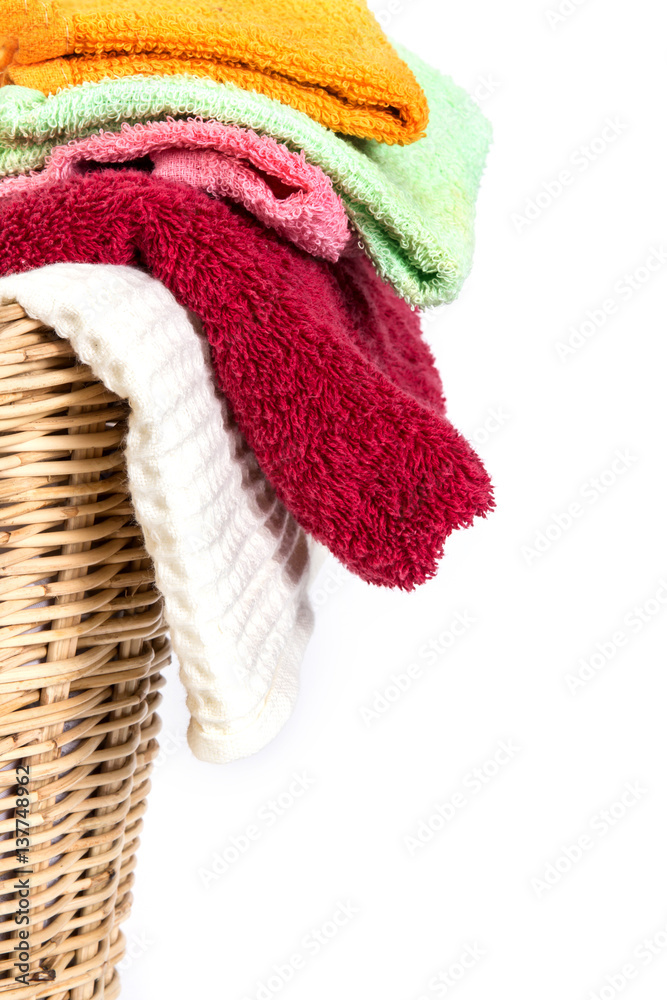 close up color mix  towel in wicker baskets on white background