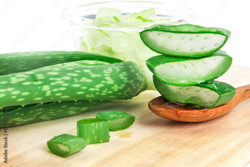 the sliced and leaf of fresh aloe vera on  wooden plate , natural clear gel as the star beauty ingre