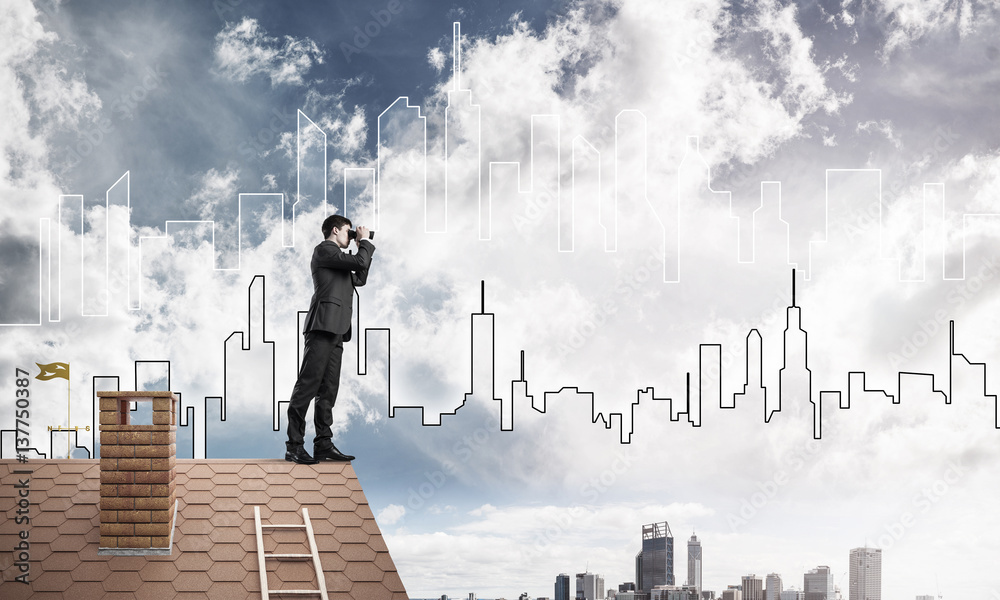 Businessman standing on roof and looking in binoculars. Mixed me