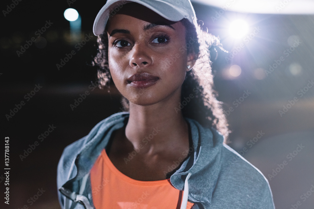 Fitness woman in city at night