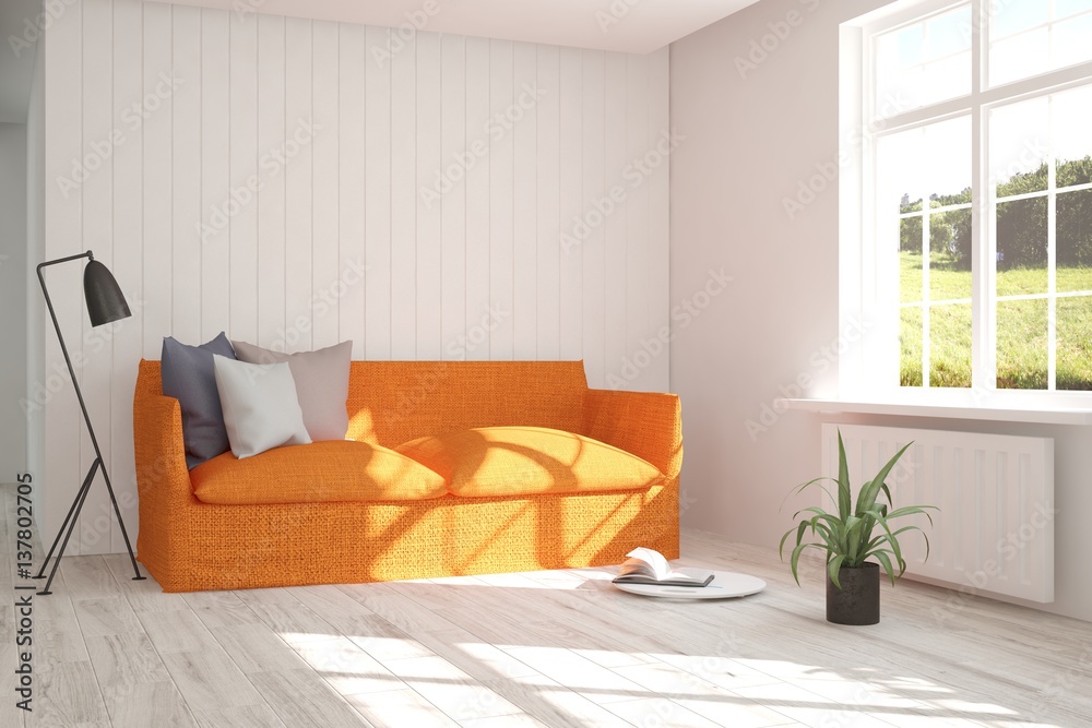 White room with orange sofa and green landscape in window. Scandinavian interior design