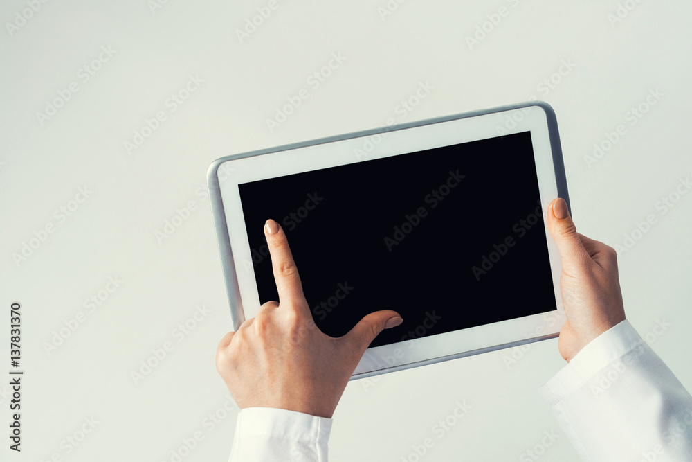 Close of female doctor hands working with tablet pc computer