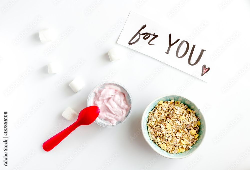 concept kid breakfast with yogurt top view white background