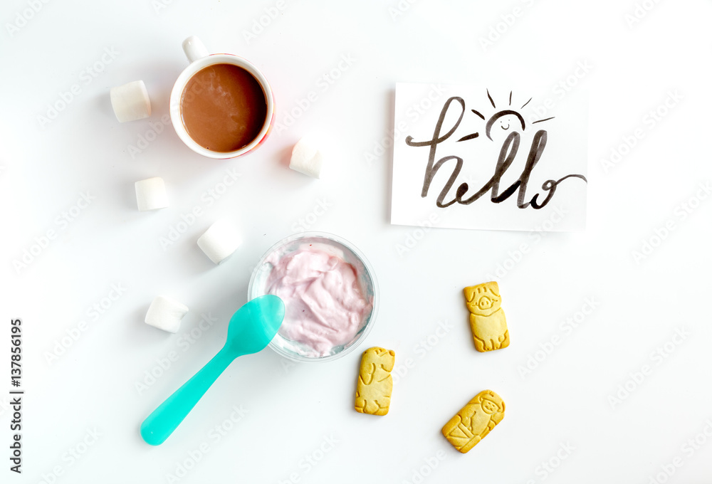 concept kid breakfast with yogurt top view white background