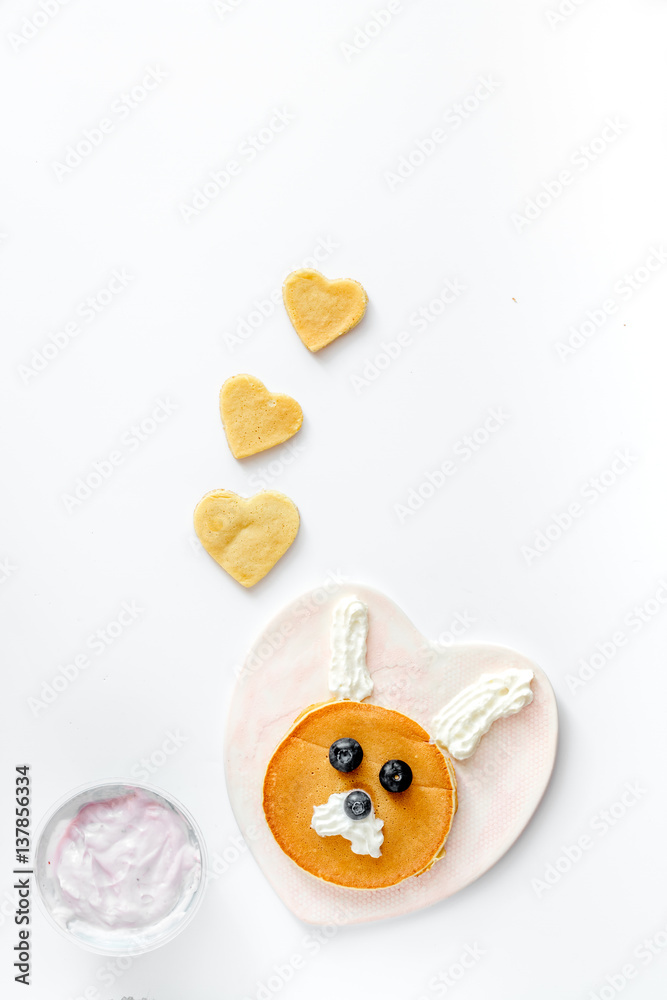 concept kid breakfast with pancake top view on white background