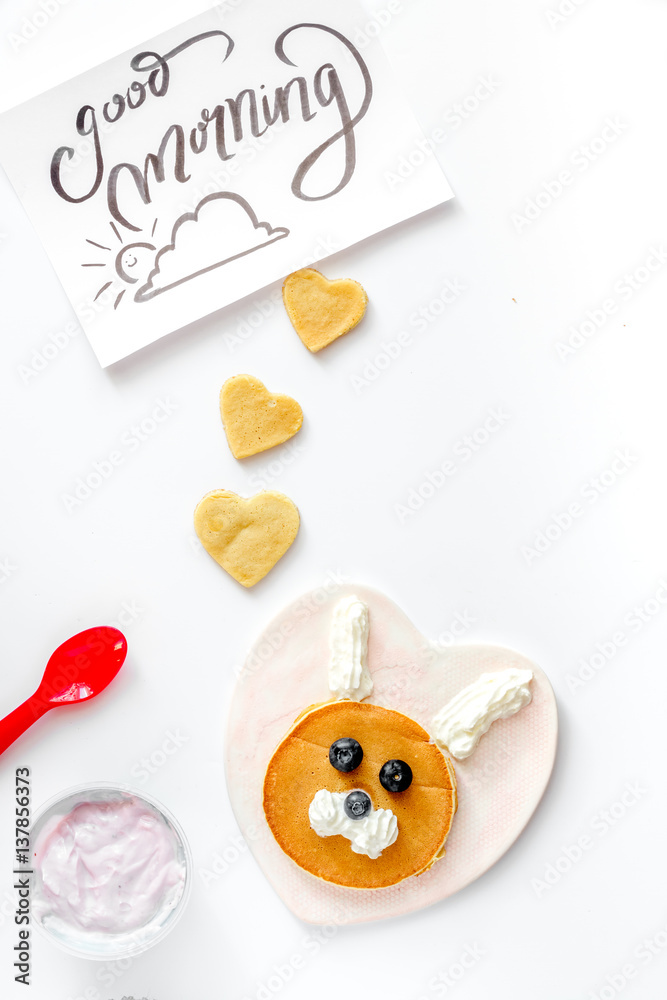 concept kid breakfast with pancake top view on white background