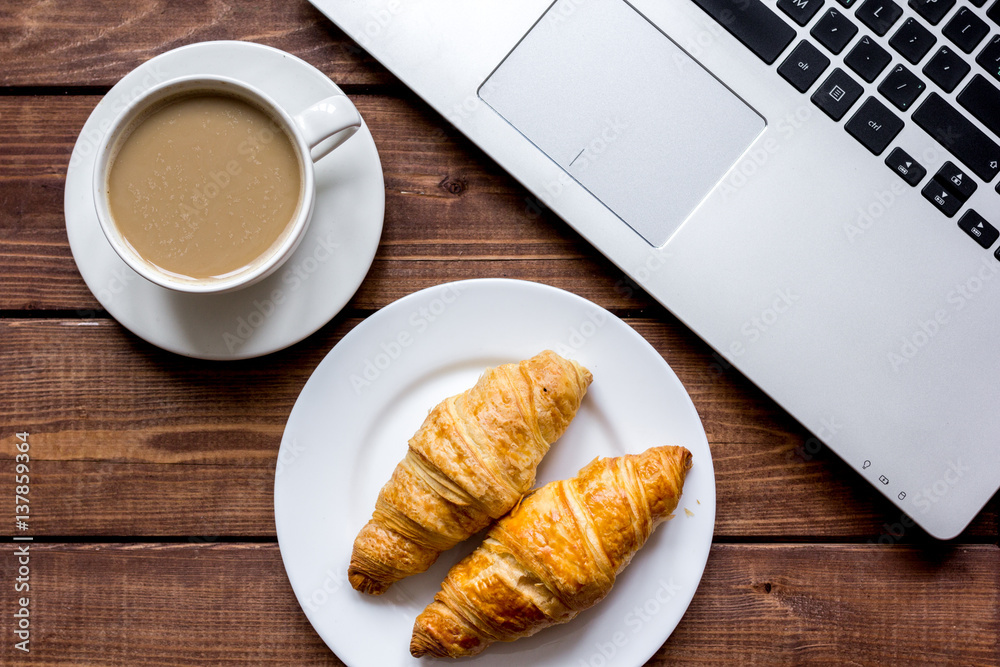 Coffee break in office on desk with laptop top view