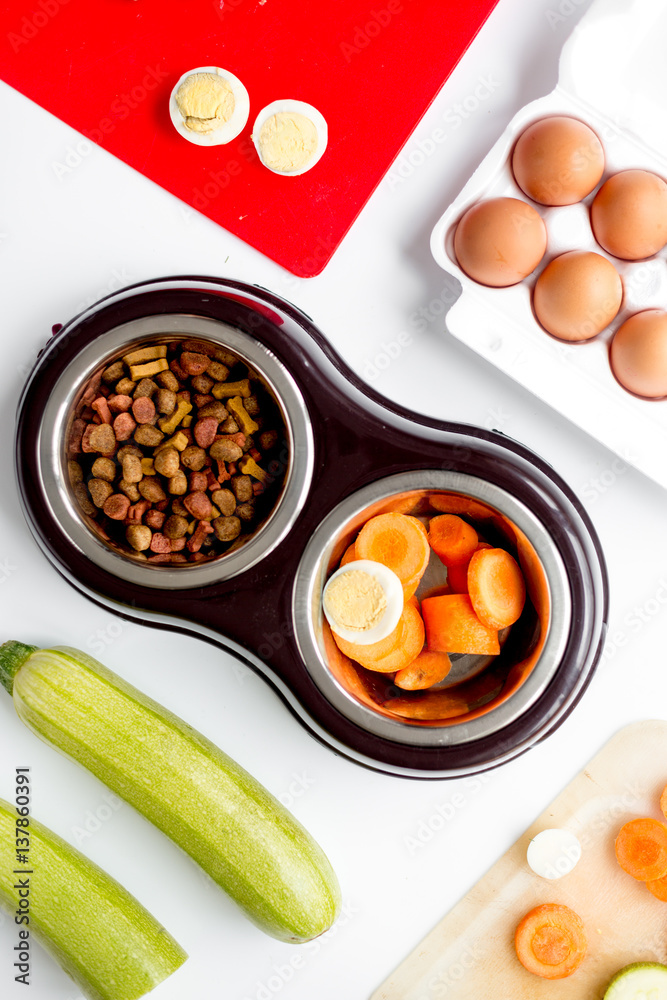 petfood set with vegetables and eggs on kitchen table background top view