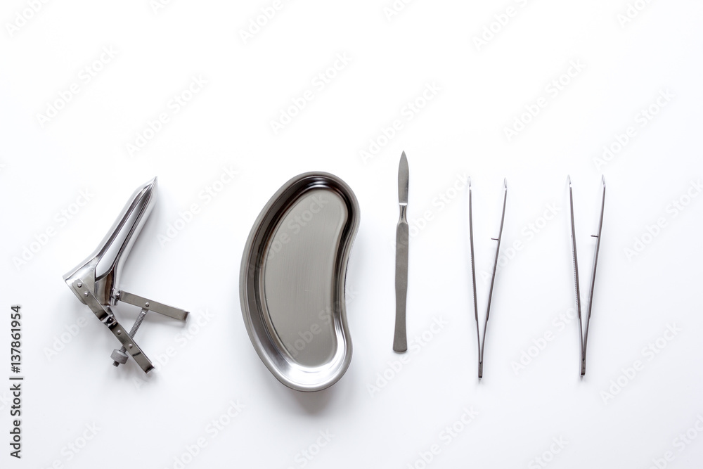 instruments of gynecologist on white background top view