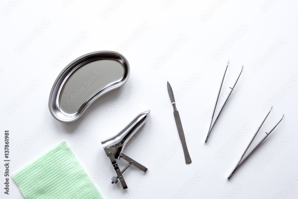 instruments of gynecologist on white background top view