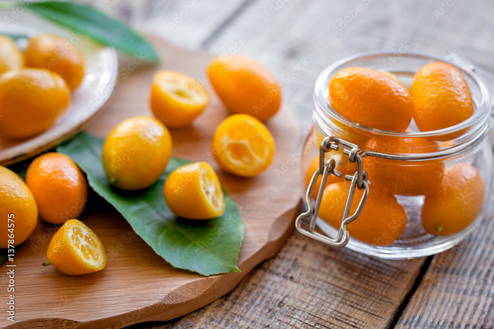 kumquat on plate at wooden table